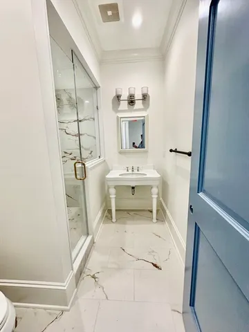 a bathroom with a shower and a sink