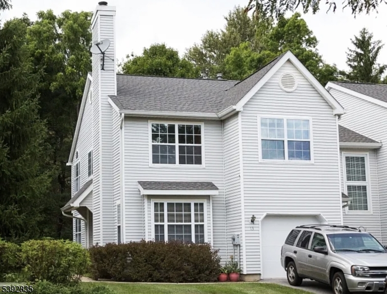 a view of a car parked in front of a house