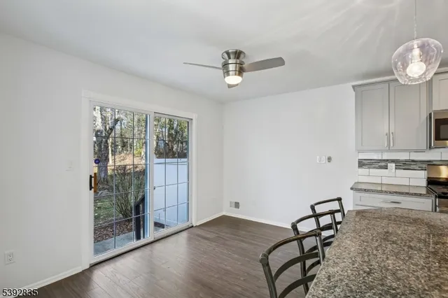 a kitchen with granite countertop a sink and cabinets
