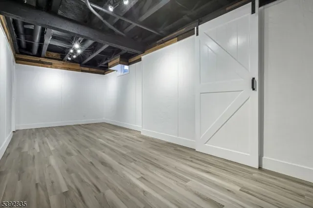 a view of a livingroom with a large window and a swimming pool