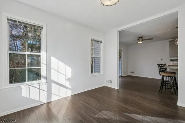 a view of washer and dryer with bathroom in the background