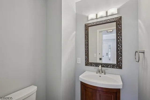 a bathroom with a granite countertop sink a toilet and shower