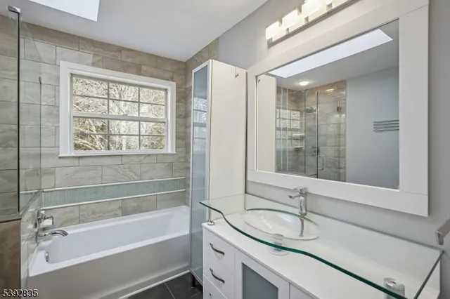 a view of a white house next to a yard