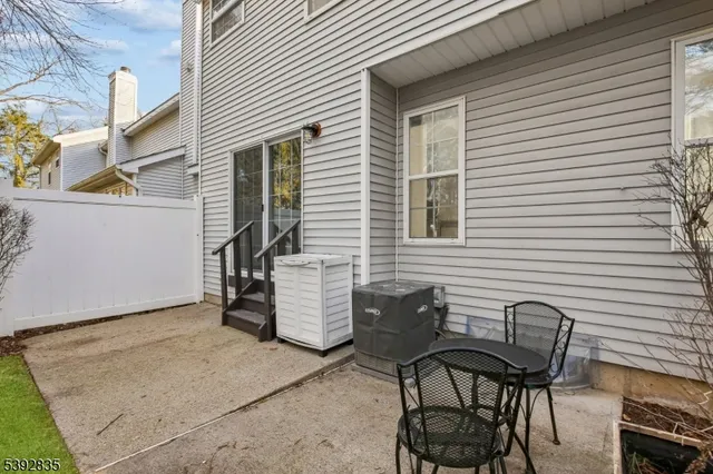 a view of a chairs and table in the back yard of the house
