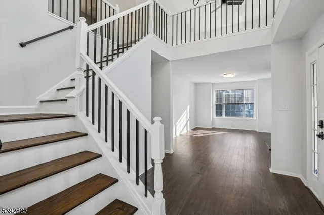 a living room with stainless steel appliances kitchen island granite countertop furniture and wooden floor
