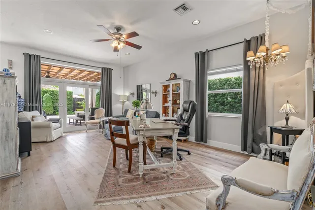 a work room with furniture and a large window