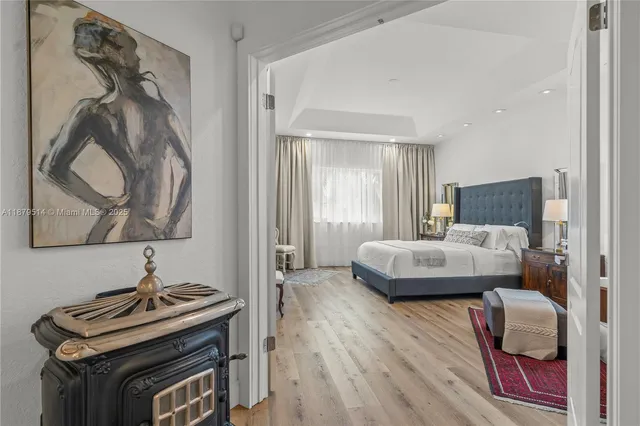 a bedroom with a bed and a painting on the wall