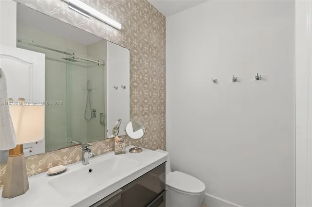 a bathroom with a sink toilet and shower