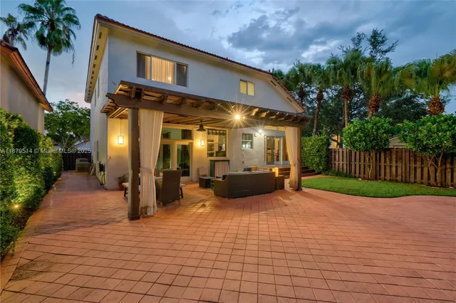 a view of a house with backyard and sitting area