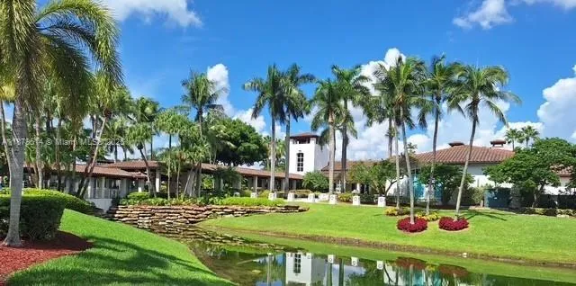 a front view of multi story residential apartment building with yard