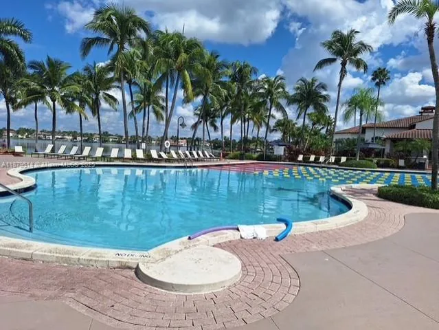 a view of a swimming pool with a patio and a garden
