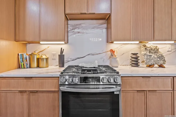 a stove top oven sitting inside of a kitchen