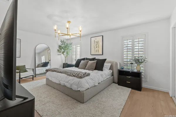 a bedroom with bed and a chandelier