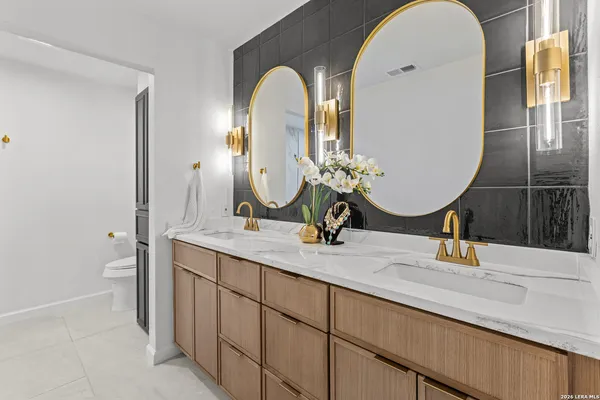 a bathroom with a double vanity sink and a mirror