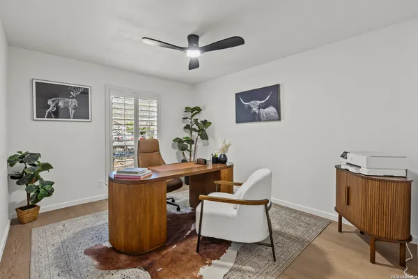 a view of backyard with table and chairs and a large tree