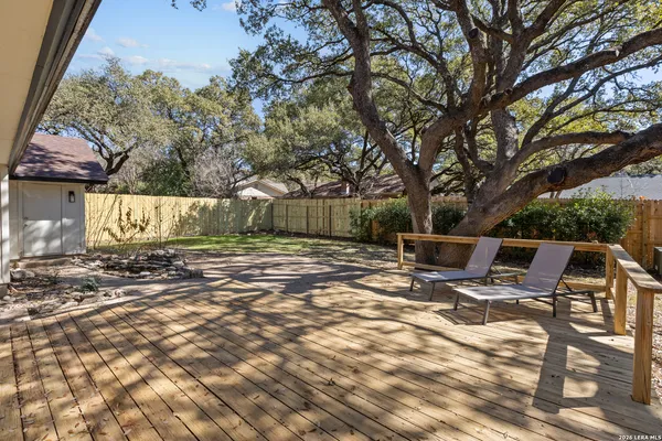a view of backyard of house with green space