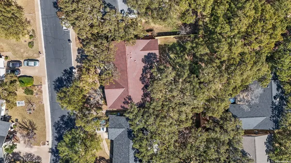 an aerial view of house with yard and mountain view in back