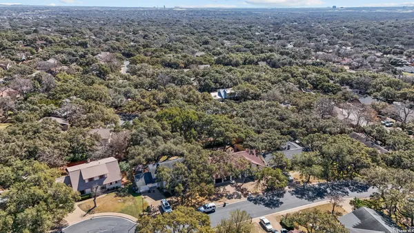 an aerial view of residential house with parking and yard