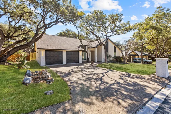a brick house with trees in front of it