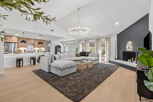 a living room with furniture and a chandelier