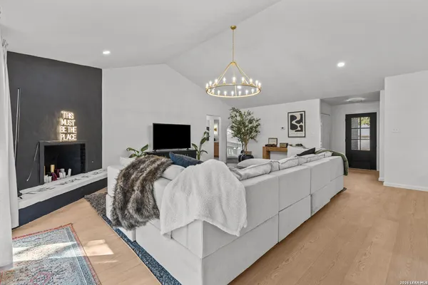 a living room with furniture and a chandelier