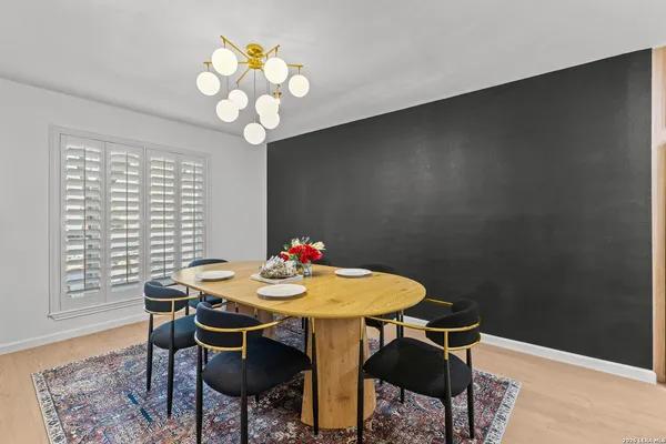 a view of a dining room with furniture and chandelier