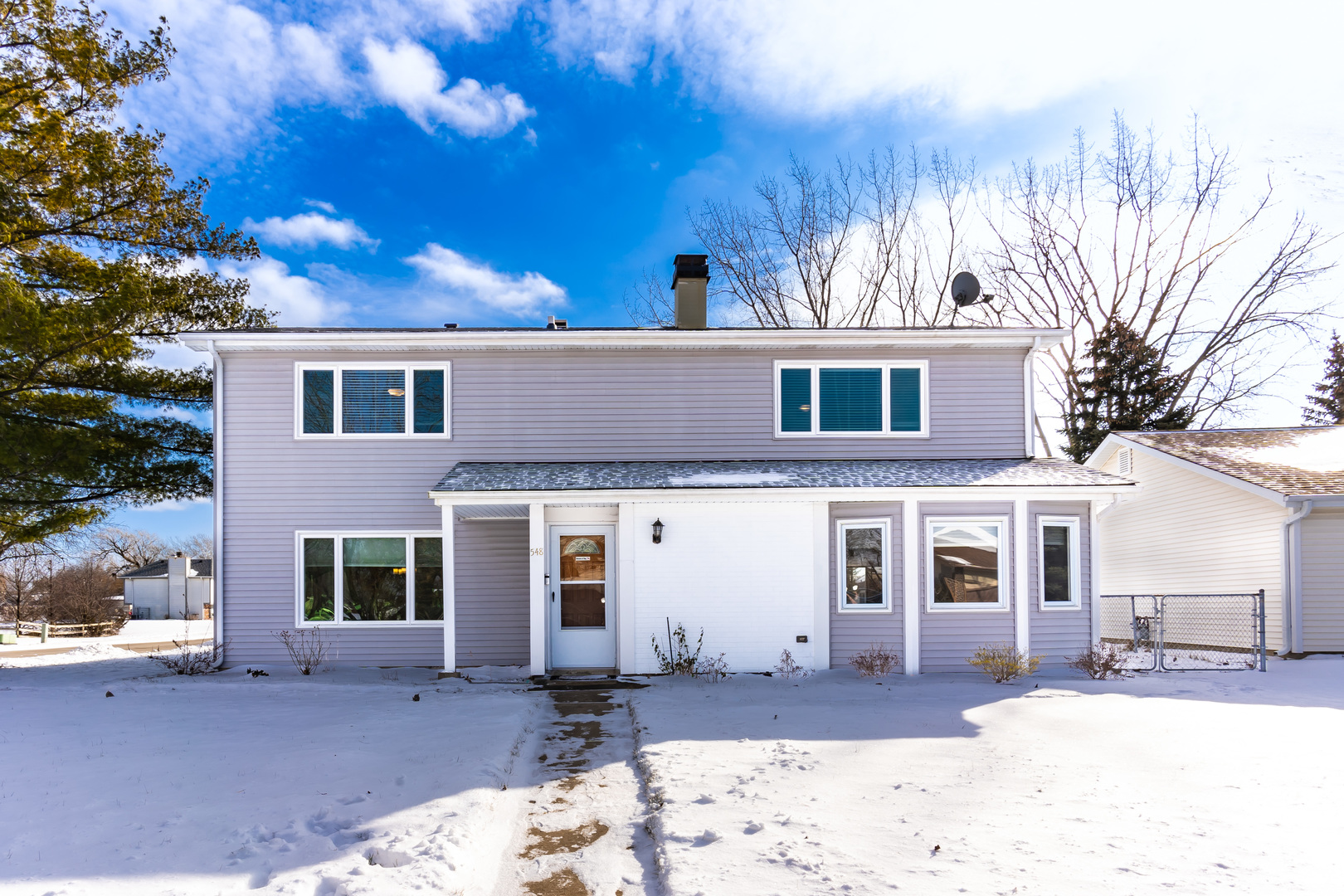 548 Harbor Terrace Bartlett, IL 60103 - Photo 1 of 42 a front view of a house with a yard covered with snow in front of house
