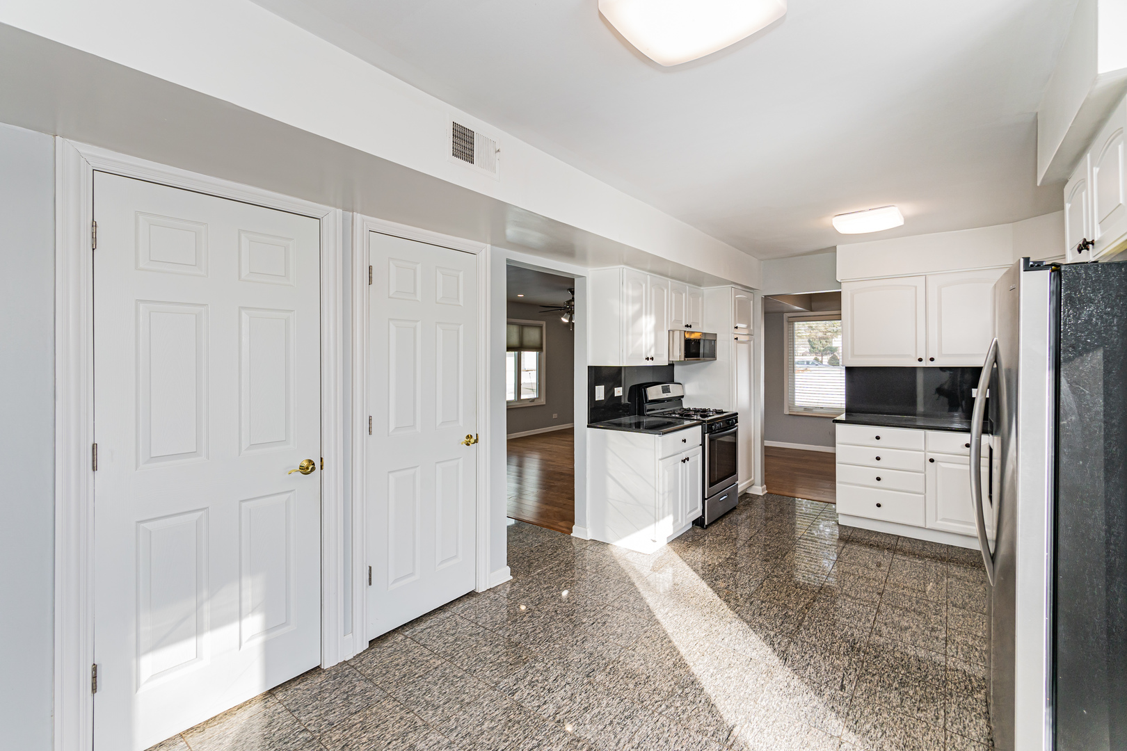 548 Harbor Terrace Bartlett, IL 60103 - Photo 11 of 42 a kitchen with refrigerator and white cabinets