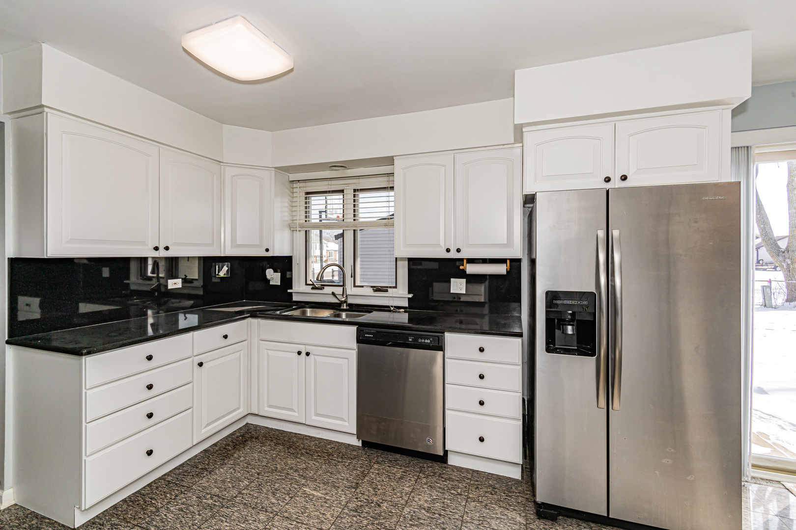 548 Harbor Terrace Bartlett, IL 60103 - Photo 12 of 42 a kitchen with granite countertop white cabinets and refrigerator