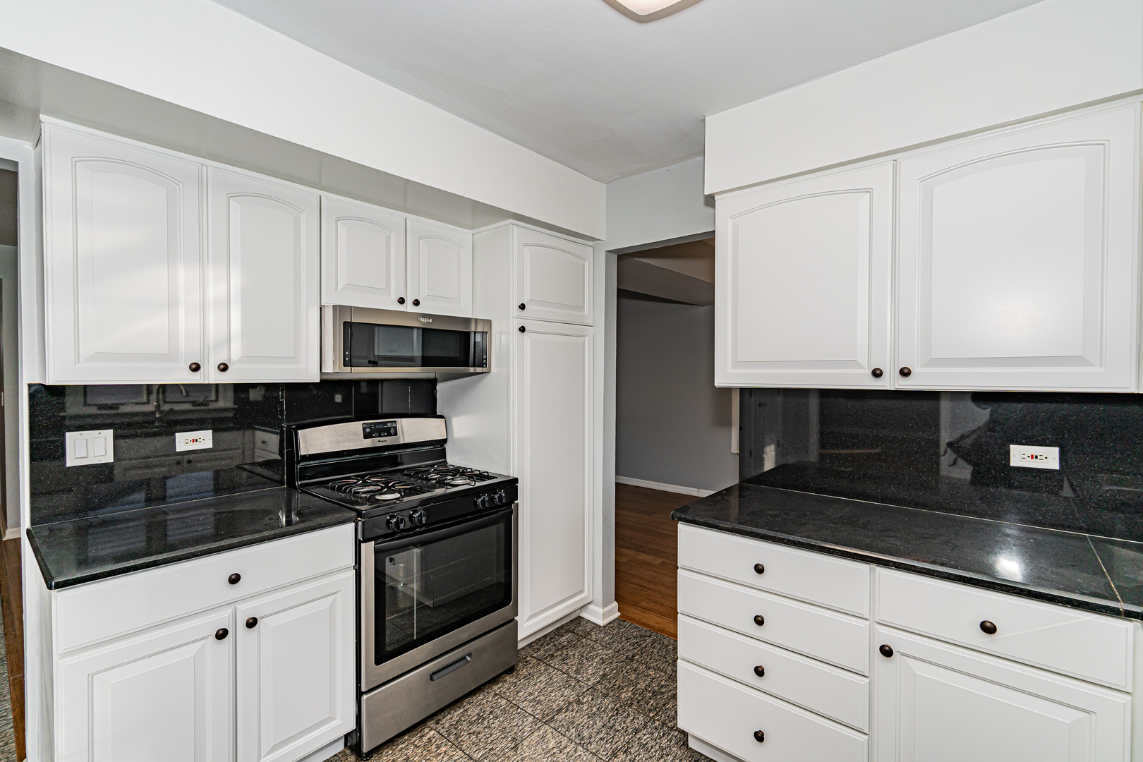 548 Harbor Terrace Bartlett, IL 60103 - Photo 13 of 42 a kitchen with white cabinets and appliances