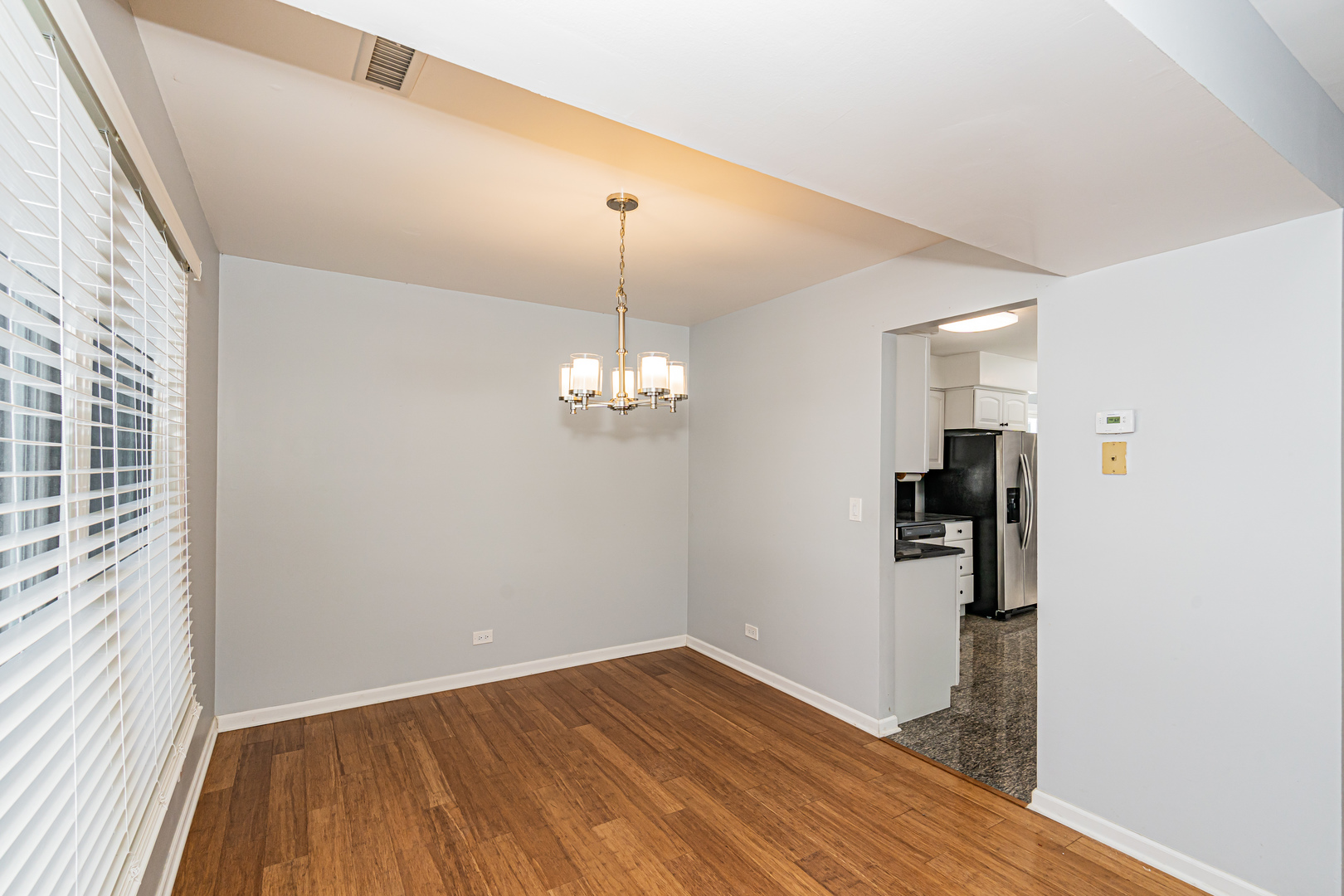 548 Harbor Terrace Bartlett, IL 60103 - Photo 20 of 42 a view of a room with wooden floor staircase and a kitchen