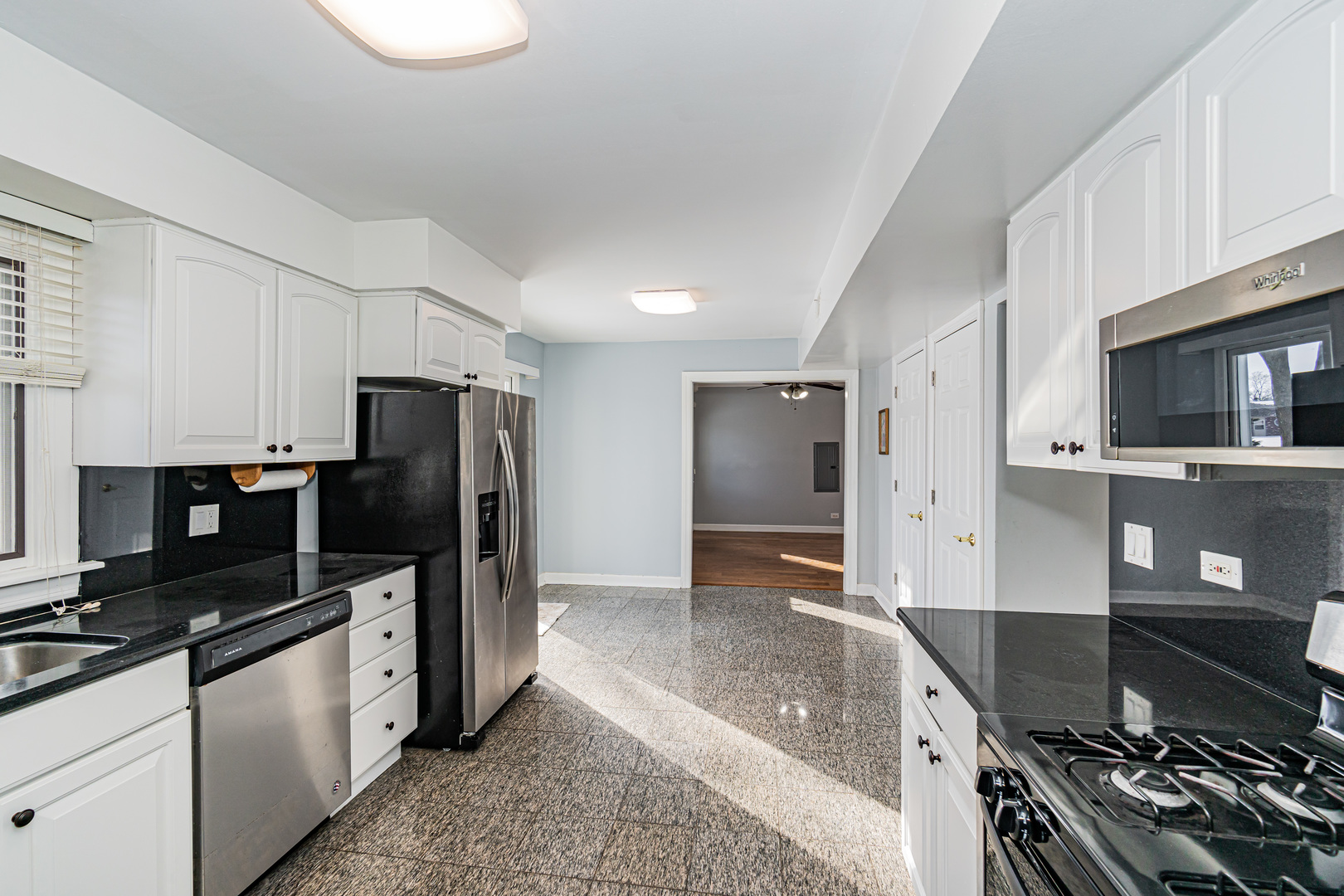 548 Harbor Terrace Bartlett, IL 60103 - Photo 6 of 42 a kitchen with stainless steel appliances granite countertop a stove refrigerator and microwave