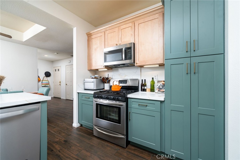 3707 Calle Curacso Riverside, CA 92503 - Photo 3 of 43 a kitchen with stainless steel appliances granite countertop a stove a sink and a microwave