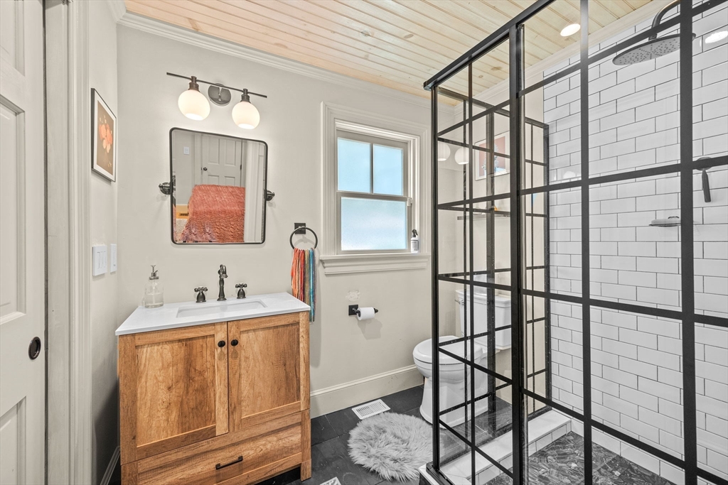 90 Dodge Street Beverly, MA 01915 - Photo 15 of 37 a bathroom with a sink mirror and a shower