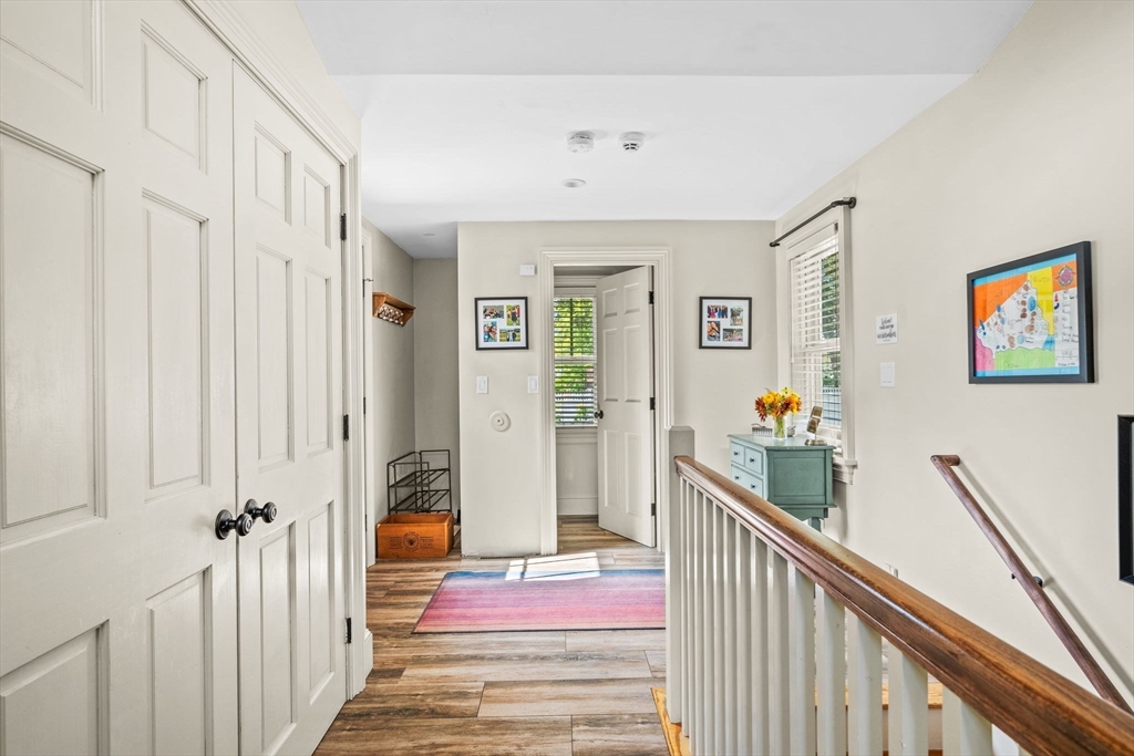 90 Dodge Street Beverly, MA 01915 - Photo 25 of 37 a view of a hallway with paintings on the walls