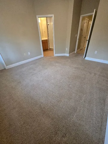 a spacious bathroom with a double vanity sink a large mirror and a bathtub