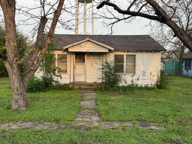 501 Reagan Street South West, TX 76691 - Photo 2 of 12 a front view of a house with a garden