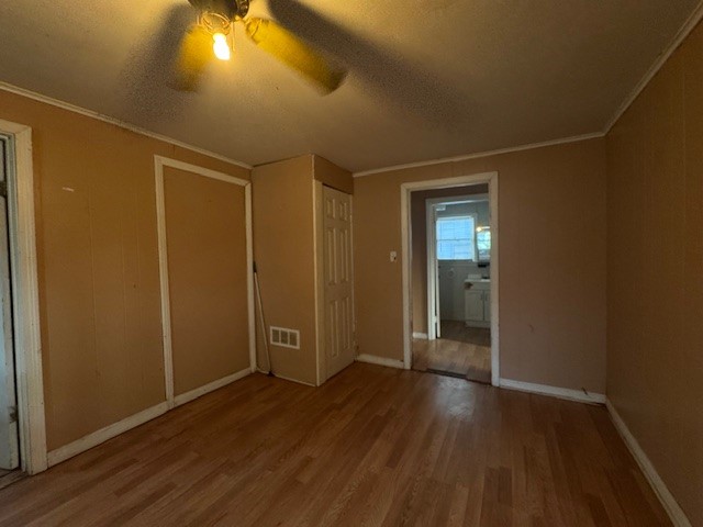 501 Reagan Street South West, TX 76691 - Photo 5 of 12 an empty room with wooden floor and windows
