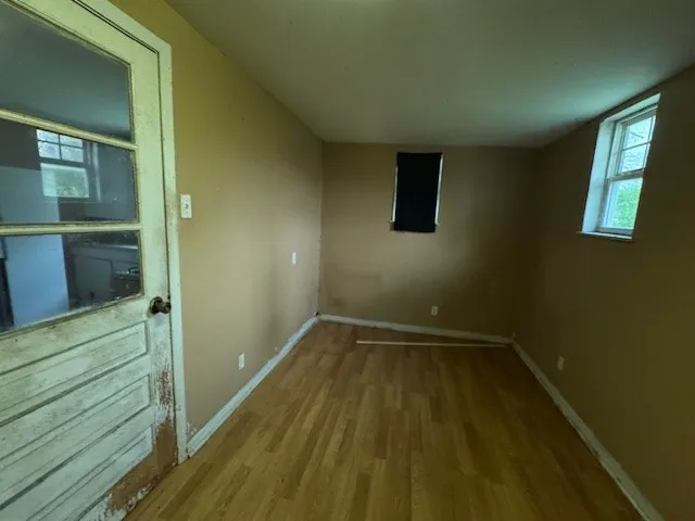 a view of wooden floor and windows in a room