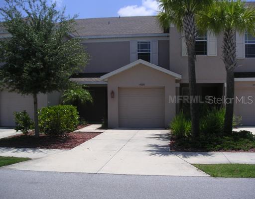 14928 Skip Jack Loop Lakewood Ranch, FL 34202 - Photo 1 of 1 a front view of a house with garden