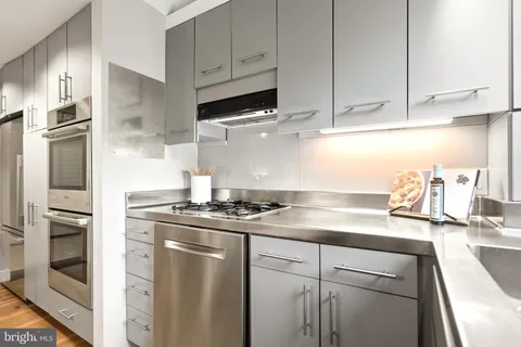 a kitchen with a sink and large window