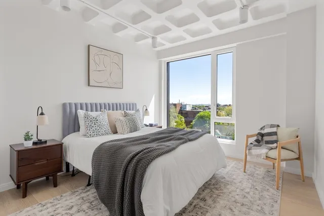 a bed room with a bed and a chair