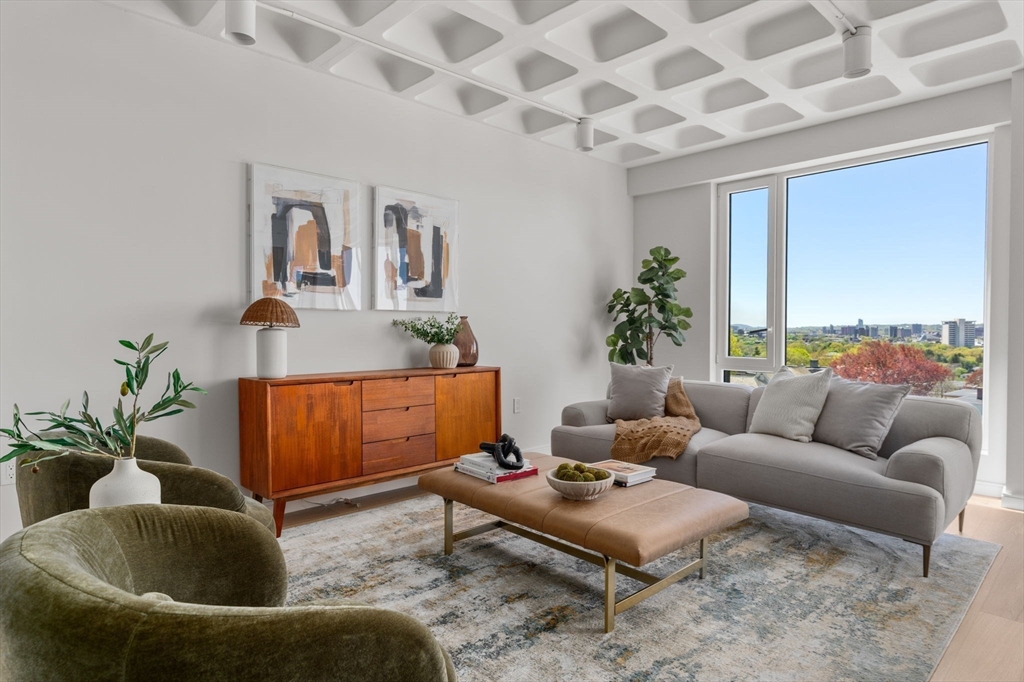 125 Lowell Street, Unit 402 Somerville, MA 02143 - Photo 4 of 34 a living room with furniture and a potted plant