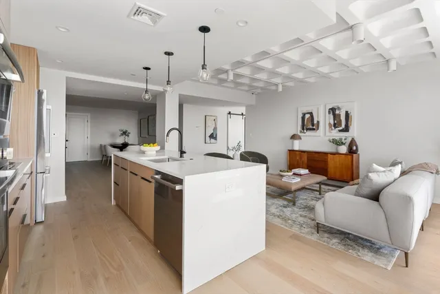 a living room with furniture and a chandelier