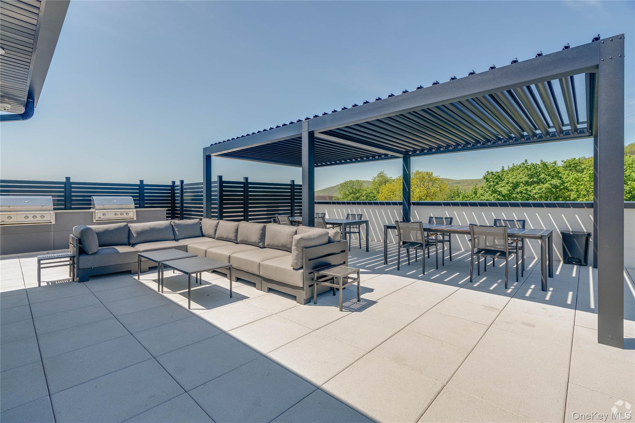 15 Washington Avenue, Unit 102 Suffern, NY 10901 - Photo 24 of 31 a outdoor living space with patio furniture and garden view