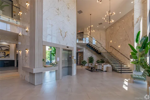 a lobby with furniture and potted plants