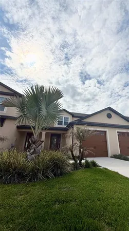 a front view of house with a garden