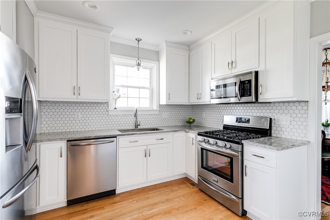 5108 King William Road Richmond, VA 23225 - Photo 11 of 38 a kitchen with stainless steel appliances granite countertop a sink a stove and microwave