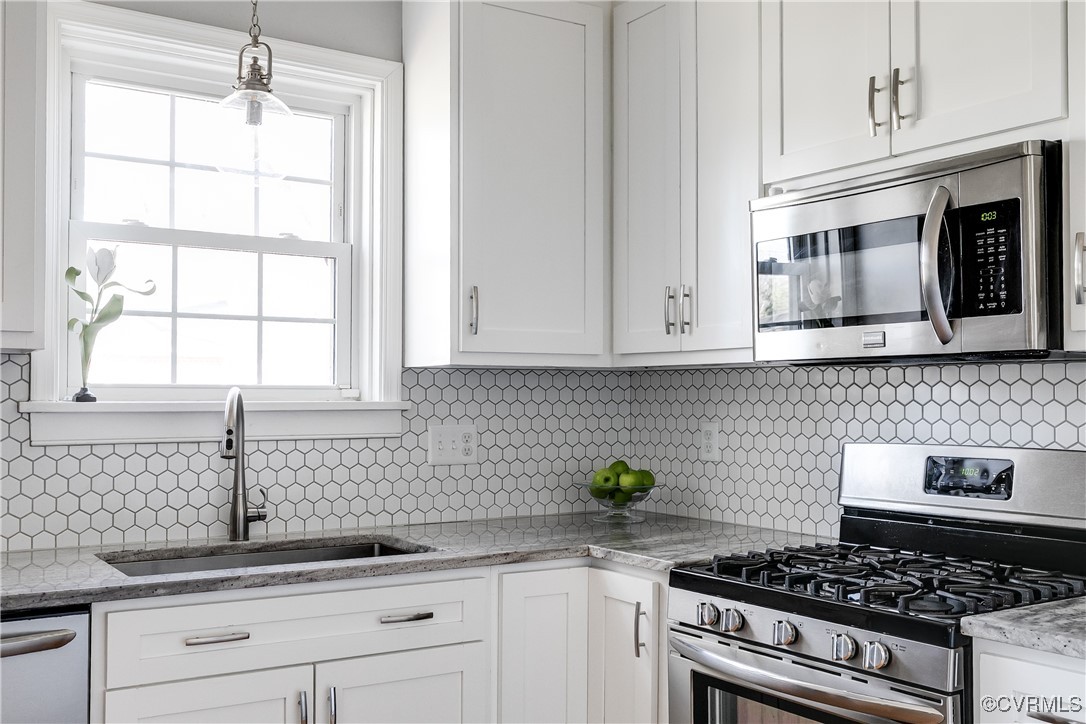 5108 King William Road Richmond, VA 23225 - Photo 12 of 38 a kitchen with stainless steel appliances granite countertop white cabinets and a stove