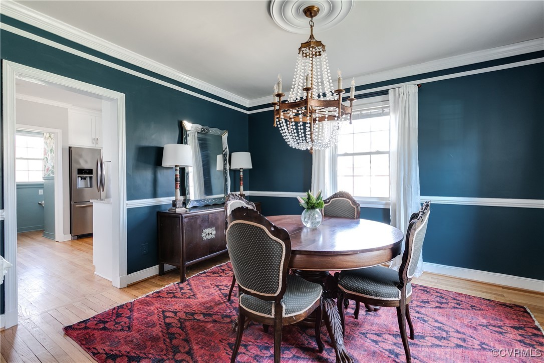 5108 King William Road Richmond, VA 23225 - Photo 9 of 38 a dining room with furniture a chandelier and wooden floor